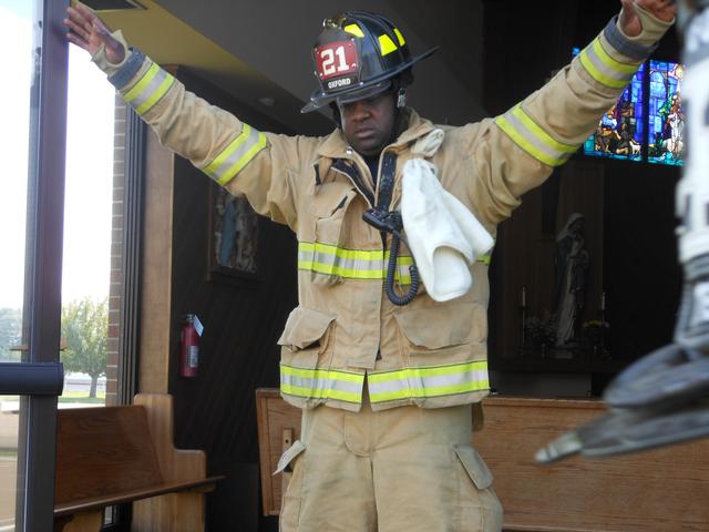 Firefighter Tim Greene rejoicing after a first due fire in a church.